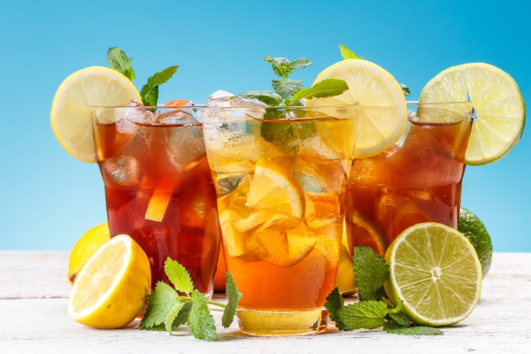 Assorted colorful iced teas on a marble café counter
