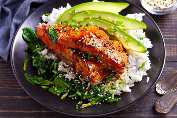 Close-up of salmon grain bowl on a wooden table
